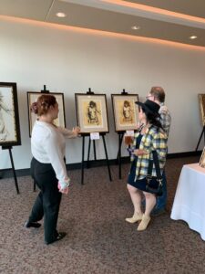 People viewing art in a gallery exhibit.