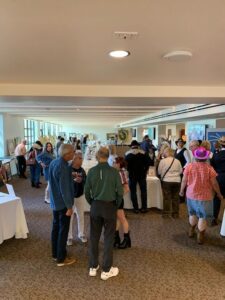 Art exhibition with people viewing displays.