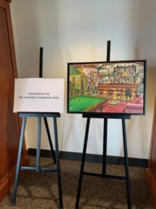 Painting and sign on easels in room.
