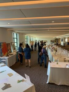 People browsing art in a gallery exhibit.