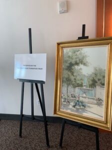 Painting and sign on easels in room.