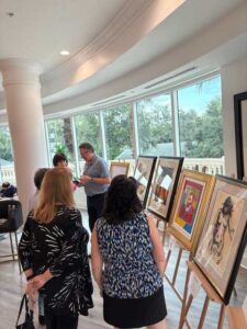 People viewing artwork in a gallery setting.