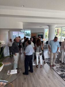 People socializing in a spacious, bright room.