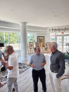 People conversing at an art gallery event.