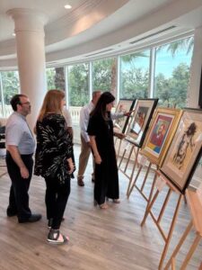 People viewing paintings in a gallery.