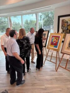 People viewing artwork in a gallery setting.