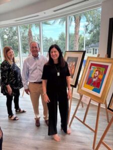 People enjoying an art gallery exhibition.