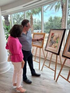 Couple admiring paintings in art gallery.