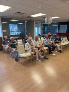 People seated in a meeting room.