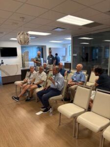 Group of men sitting in a meeting.
