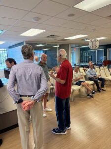 People socializing in a meeting room.
