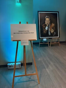 Art display with easel and painting.