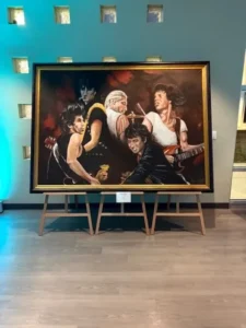 Painting of a rock band on display.