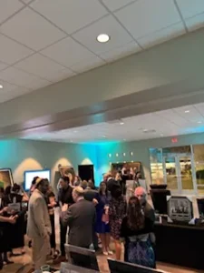 People socializing at indoor event gathering.