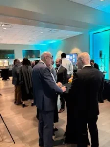 People networking at a formal event.