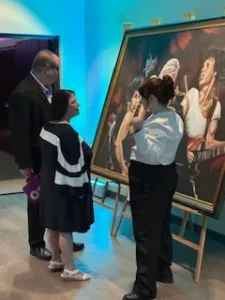 People viewing artwork in a gallery.