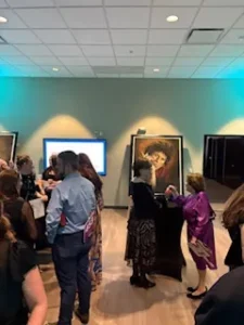 People socializing at an art gallery event.