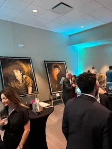 Art gallery event with large portraits displayed.